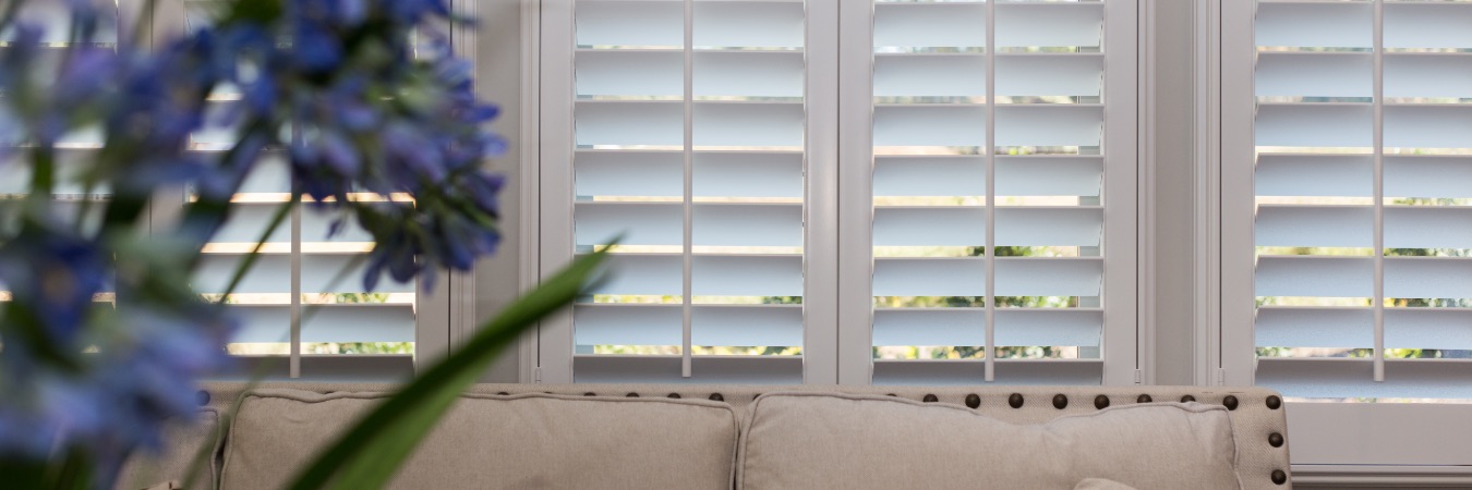 Shutters in a living room with flowers