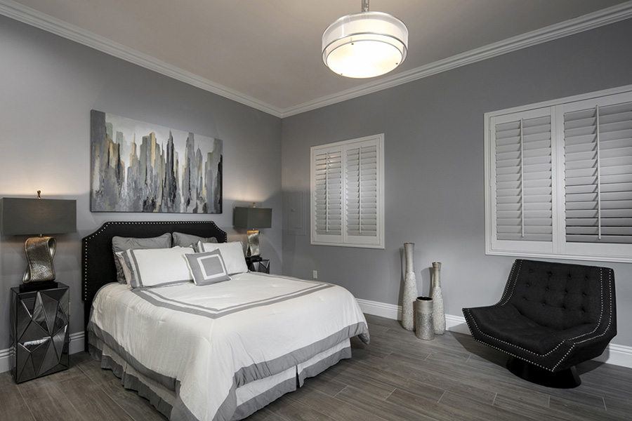White Polywood shutters in a dim bedroom
