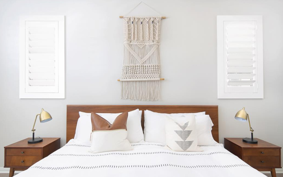 Custom-fitted louvered shutters provide excellent nighttime privacy in Houston. Photo Credit: Audrey Crisp Louvered shutters in a bedroom.