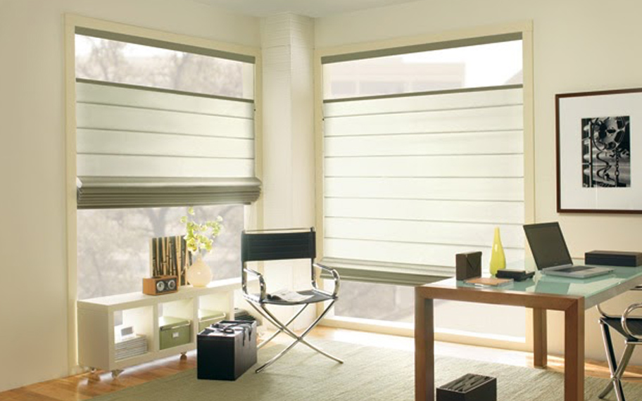 Upgrade your windows with stylish window shades or shutters in Houston. Stylish sheer shades in the corner of a modern office.
