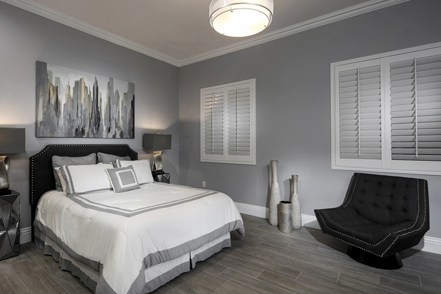Close your custom Polywood shutters to beat the heat and keep your Houston bedroom cool. White Polywood shutters on bedroom windows
