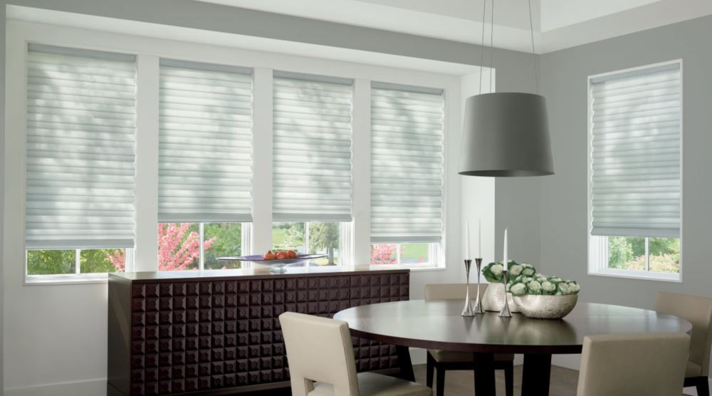 Custom cordless roller shades have a clean look and are appropriate for any room. Cordless motorized shades in a Houston dining room