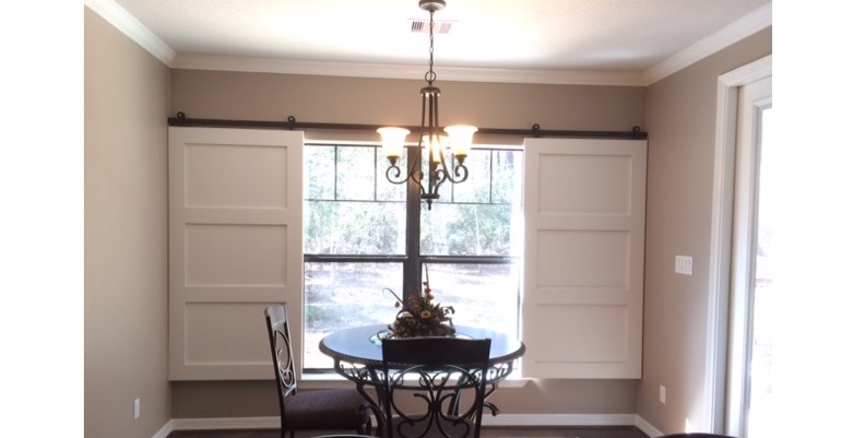Barn doors open horizontally with slides instead of cords. Houston barn door shutters