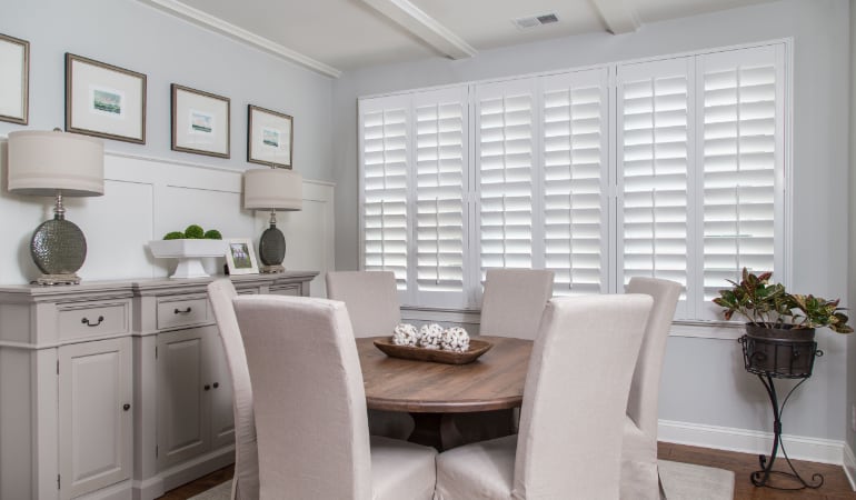 Plantation shutters are a perfect choice for homeowners looking for privacy or natural light. Plantation shutters in a Houston dining room.