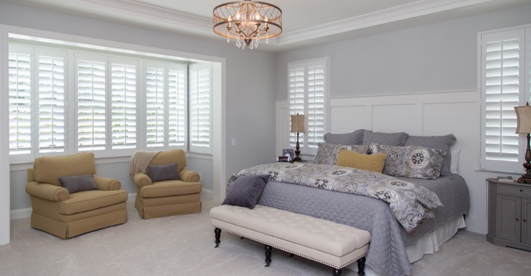 interior shutters offer subtle fashion. White shutters in Houston bedroom.