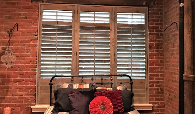 Reclaimed wood shutters give a natural feel to your minimalist spaces. Reclaimed wood shutters surrounded by brick wall.