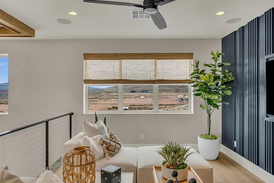 Houston homeowners who want eco-friendly home fixtures should consider natural woven shades. Natural brown woven shades on a window in a stylish sitting area