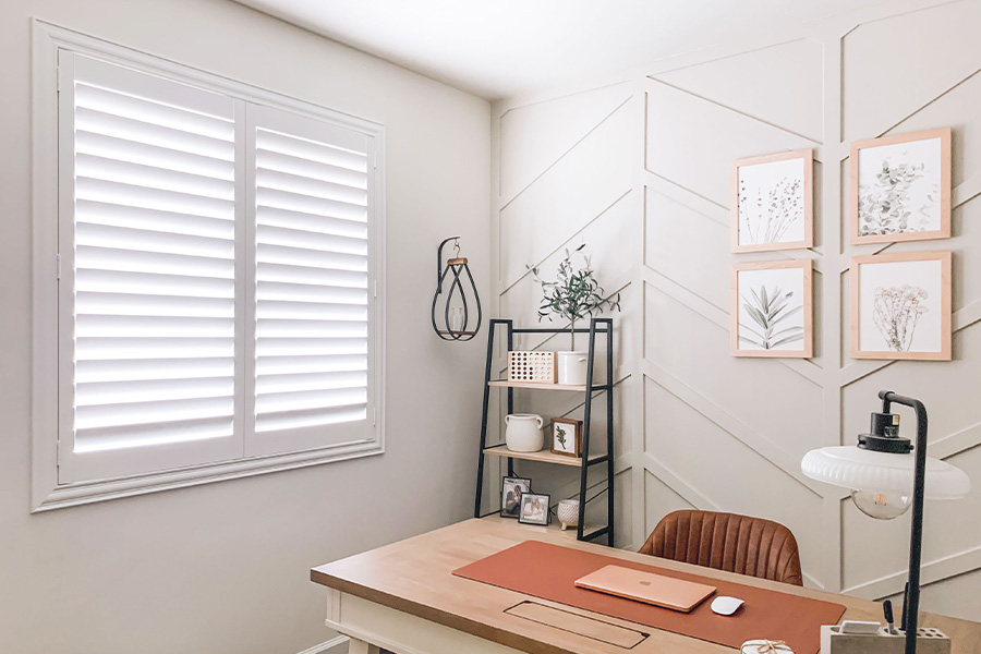 Polywood shutters give you maximum control over natural light in your Houston home. Photo Credit: @OurLakepoint Farmhouse  White and off-white farmhouse style office with natural light from polywood shutters.