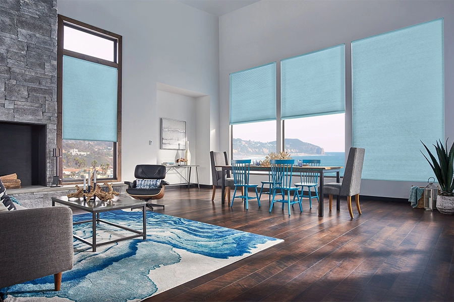 Smart motorized window shades are perfect on tall windows in your Houston home. Blue motorized shades on tall living room windows